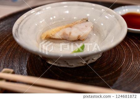 Lightly fried thread-sail filefish sashimi served in a handcrafted ceramic bowl 124681872