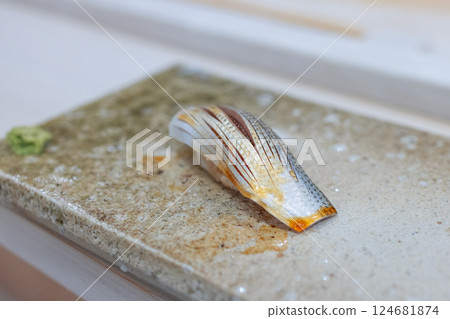 Closeup of expertly crafted gizzard shad nigiri sushi with delicate slicing and a light soy glaze Closeup of expertly crafted gizzard shad nigiri sushi with delicate slicing and a light soy glaze 124681874