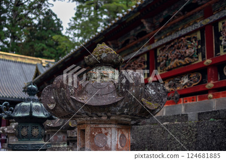 Ancient stone lantern covered in moss and lichen at Toshogu Shrine in Nikko 124681885
