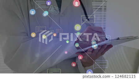 Image of media icons over caucasian male doctor writing 124682115