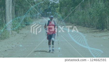 Hiking on dirt road, man with trekking poles over DNA strand image 124682591