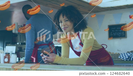 Hot dog image over woman using smartphone in food truck Hot dog image over woman using smartphone in food truck 124682640