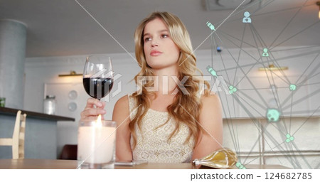 Woman enjoying glass of red wine at elegant restaurant, looking thoughtful Woman enjoying glass of red wine at elegant restaurant, looking thoughtful 124682785