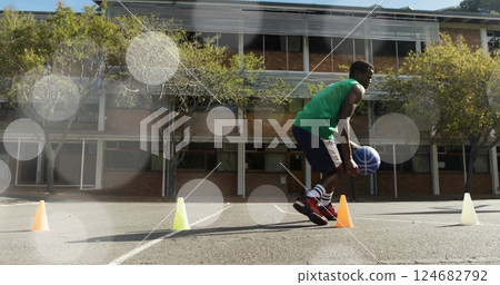 Running basketball drill, athlete training over lens flare image Running basketball drill, athlete training over lens flare image 124682792