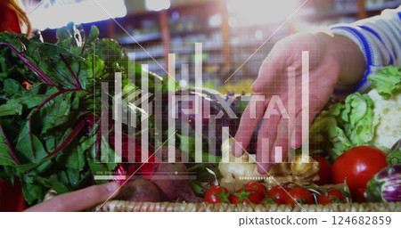 Hands picking vegetables from basket, bar chart image over produce 124682859