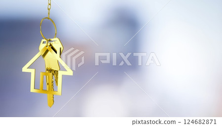 Golden house-shaped keychain image over blurred background 124682871