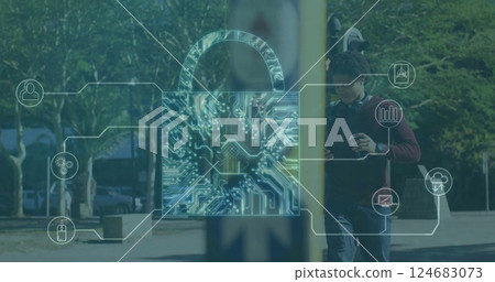 Image of padlock with icons over biracial man using smartphone and walking on street 124683073