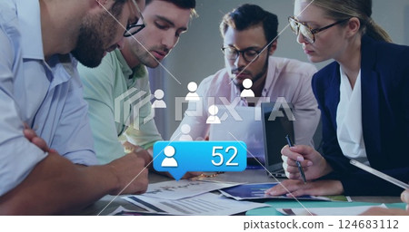 Image of social media icons with number over diverse colleagues having meeting in office 124683112