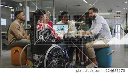 Image of diagrams over disabled and diverse colleagues discussing work in office 124683270