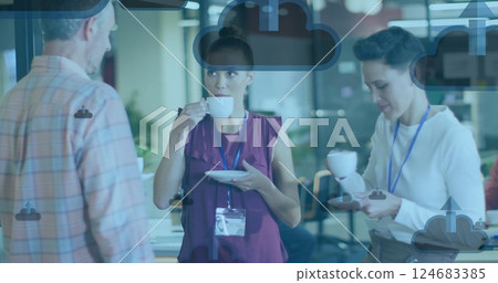 Image of clouds with arrows icons over diverse colleagues talking in office 124683385
