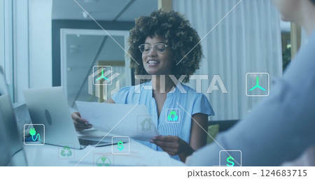 Image of ecology icons over diverse colleagues discussing work in office 124683715
