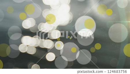 Image of glowing light spots moving over grey background Image of glowing light spots moving over grey background 124683756