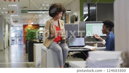 Image of financial data processing over diverse business people in office 124683800
