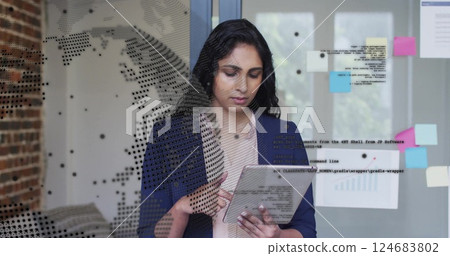 Image of financial data processing over biracial businesswoman using tablet in office Image of financial data processing over biracial businesswoman using tablet in office 124683802