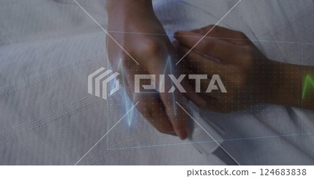 Image of cardiographs over senior biracial woman lying in hospital bed 124683838