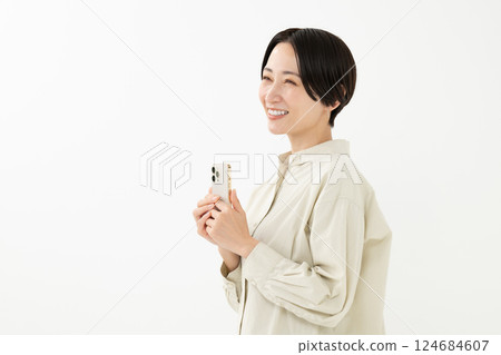 A woman operating a smartphone 124684607