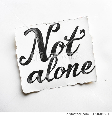 You are not alone. Inspirational phrase. hand lettering motivational inscription in black and white colors on a torn piece of paper 124684651