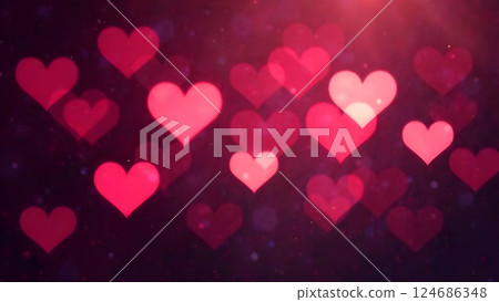 A romantic image of heart-shaped light bokeh, blurred elegantly in pink, red, and white, glowing softly against a dark, moody background 124686348