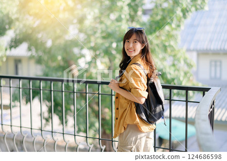 traveler young Asian woman in her 30s navigates the vibrant streets of Bangkok. Let this photo inspire your own journey. traveler young Asian woman in her 30s navigates the vibrant streets of Bangkok. Let this photo inspire your own journey. 124686598