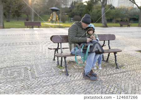 Grandfather and grandson sharing a special moment on a park bench 124687266