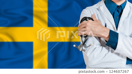 Doctor with stethoscope on Swedish flag. Doctor holding stethoscope on Swedish flag 124687267