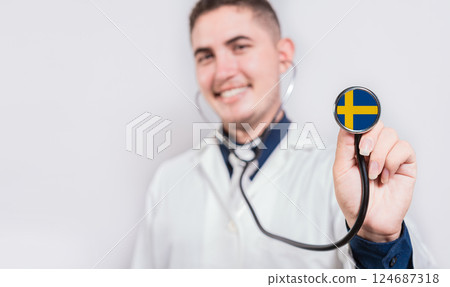 Doctor showing stethoscope with Swedish flag. Sweden national healthcare concept 124687318