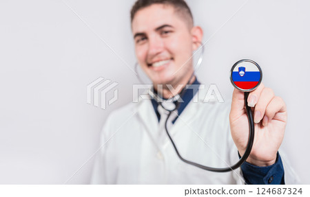 Doctor showing stethoscope with Slovenian flag. Slovenia national healthcare concept Doctor showing stethoscope with Slovenian flag. Slovenia national healthcare concept 124687324