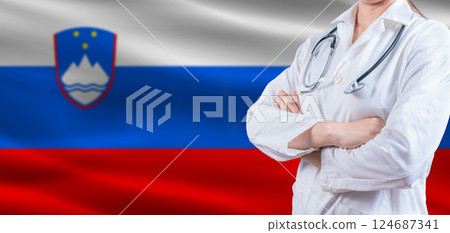 doctor with crossed arms on slovenian flag; slovenia health and care concept; female doctor on slovenian flag doctor with crossed arms on slovenian flag; slovenia health and care concept; female doctor on slovenian flag 124687341