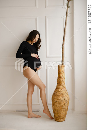 Pregnant Woman Posing with Modern Elegance 124687762