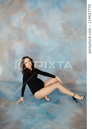 Confident Woman Posing in Stylish Black Outfit 124687770