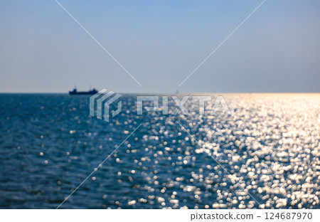Abstract blur reflection on the water surface with Silhouette ship, Water bokeh in the sea. 124687970