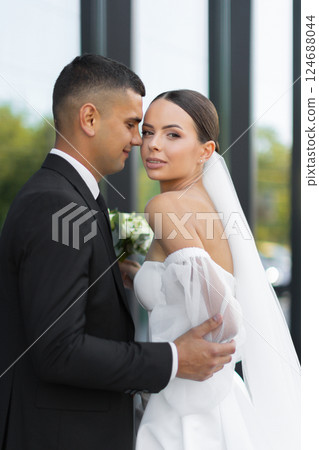 Groom embracing bride during wedding day 124688044