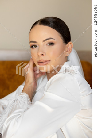 Bride wearing veil and white shirt is getting ready for wedding ceremony Bride wearing veil and white shirt is getting ready for wedding ceremony 124688069