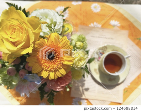 Yellow flower arrangement and tea 124688814