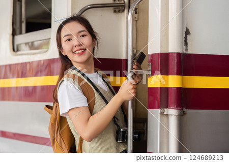 Travel and New Beginnings. A woman confidently boards a train, ready for her journey. 124689213