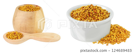 Bee pollen grains in wooden and ceramic bowl and spoon isolated on white background Bee pollen grains in wooden and ceramic bowl and spoon isolated on white background 124689483