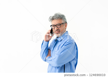 A man wearing work clothes A man wearing work clothes 124690010