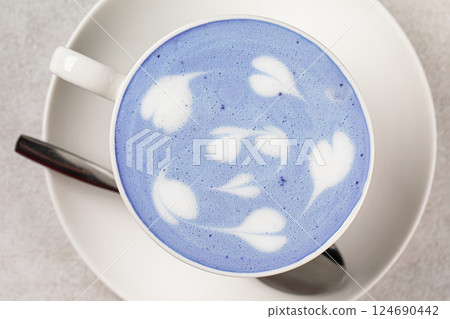 Portion of blue matcha latte in white cup 124690442
