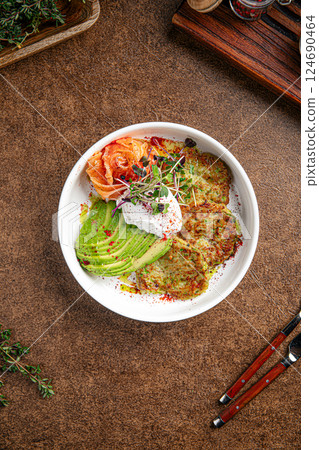 Breakfast with poached eggs zucchini pancakes Breakfast with poached eggs zucchini pancakes 124690464