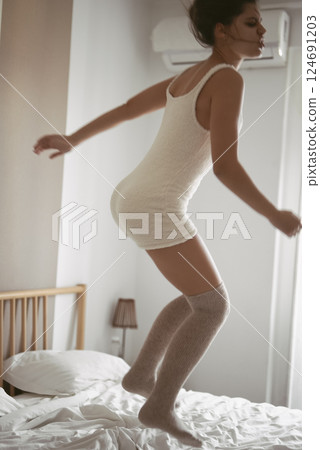 A Playful Moment on Bed in a Cozy and Inviting Room Creating a Joyful Atmosphere A Playful Moment on Bed in a Cozy and Inviting Room Creating a Joyful Atmosphere 124691203