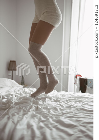 Joyful and Invigorating Morning Jump on the Bed While Wearing a Cozy and Comfortable Outfit Joyful and Invigorating Morning Jump on the Bed While Wearing a Cozy and Comfortable Outfit 124691212