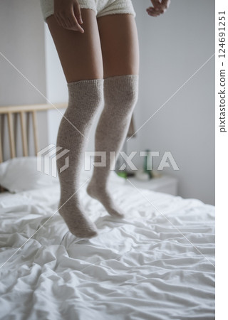 Enjoying Joyful Moments on a Cozy Bed While Wearing KneeHigh Socks for Comfort and Style Enjoying Joyful Moments on a Cozy Bed While Wearing KneeHigh Socks for Comfort and Style 124691251