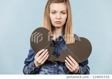 Young woman with broken heart 124691310