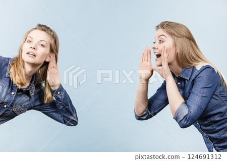Two women telling tales, rumors gossip 124691312
