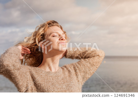 Happy woman outdoor wearing jumper 124691346