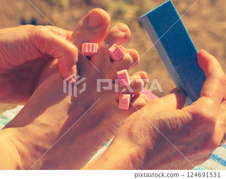 Woman pedicure outdoor Woman pedicure outdoor 124691531