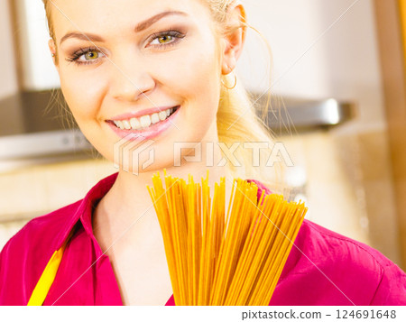 Woman holding long pasta Woman holding long pasta 124691648