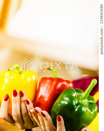 Woman holding bell peppers paprika 124691680