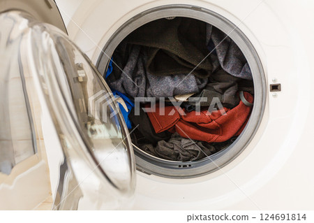 Dark clothes in washing machine. 124691814