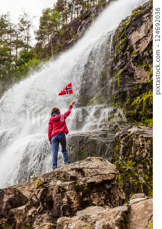 Tourist woman at waterfall Svandalsfossen, Norway Tourist woman at waterfall Svandalsfossen, Norway 124692036